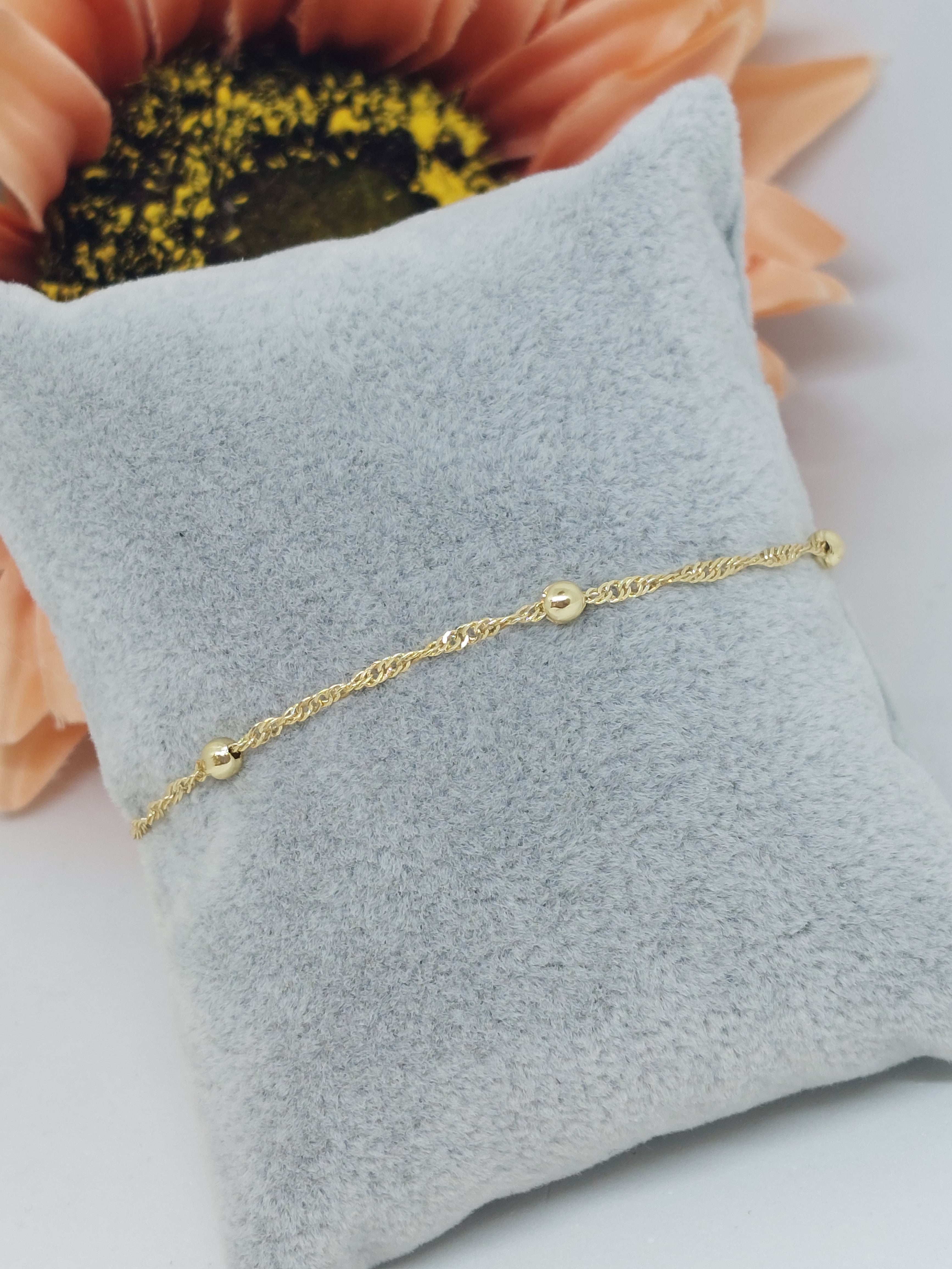 Armbandje balls twisted goudkleurig (RVS)